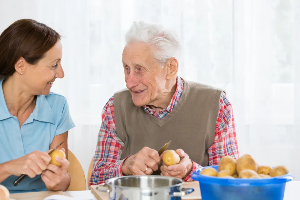 Older man receiving help in the home.