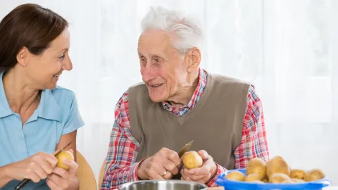 Older man receiving help in the home.